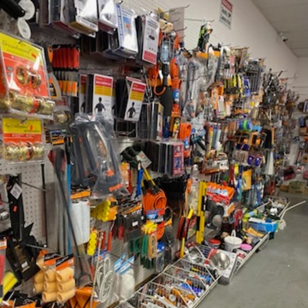 A wall of various hardware and household items for sale at Planada Cafe & Variety.