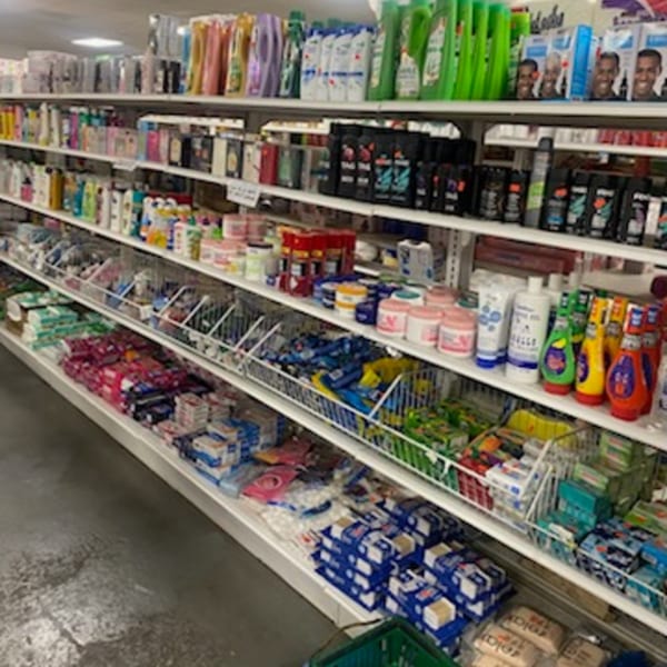 Shelves filled with various packaged goods, including toiletries, cleaning supplies, and other household items.