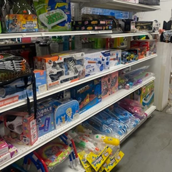 Shelves filled with various toys and household items at Planada Cafe & Variety.
